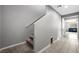 Hallway with tile floors leading to a living room with a view of a staircase to the upper level at 5631 Hill Cliff Ct, North Las Vegas, NV 89031