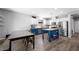 Kitchen with white cabinets, an island, stainless appliances, and an open dining area at 5631 Hill Cliff Ct, North Las Vegas, NV 89031