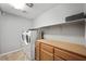 Functional laundry room with modern appliances, storage cabinets, and a clean, organized layout at 5631 Hill Cliff Ct, North Las Vegas, NV 89031