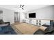 Comfortable living room with a large screen television, ceiling fan and backyard access at 5631 Hill Cliff Ct, North Las Vegas, NV 89031