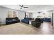 Open concept living room with lots of seating, ceiling fan and natural light at 5631 Hill Cliff Ct, North Las Vegas, NV 89031