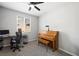 Office space features a desk, piano, and natural light from the window at 5631 Hill Cliff Ct, North Las Vegas, NV 89031