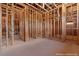 The primary bathroom is under construction with wood framing, installed ventilation, and unfinished concrete floors at 5855 St Ebbes Ct, Las Vegas, NV 89131