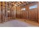 A primary bathroom under construction features wooden framing, pre-installed plumbing, and natural light from the small windows at 5855 St Ebbes Ct, Las Vegas, NV 89131