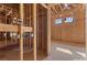 An unfinished bedroom exhibits wood framing, essential wiring, and window openings, revealing construction progress at 5855 St Ebbes Ct, Las Vegas, NV 89131