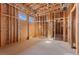 A third unfinished bedroom under construction shows wooden framing, ventilation ducts, and a window for natural light at 5855 St Ebbes Ct, Las Vegas, NV 89131