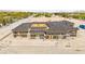 A new home construction features a unique courtyard design and sturdy roofing, set against a desert landscape at 5855 St Ebbes Ct, Las Vegas, NV 89131