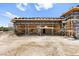 Exterior view of a house under construction with scaffolding and black moisture barrier at 5855 St Ebbes Ct, Las Vegas, NV 89131