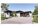 Contemporary home showcasing a multi-car garage, desert landscaping, and modern architectural details at 5855 St Ebbes Ct, Las Vegas, NV 89131