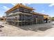 Exterior view of a house under construction with scaffolding and black moisture barrier at 5855 St Ebbes Ct, Las Vegas, NV 89131