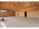 Unfinished garage featuring concrete flooring, exposed wood framing and roof beams at 5855 St Ebbes Ct, Las Vegas, NV 89131