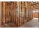 An unfinished hallway exhibiting wood framing and essential wiring, revealing construction progress at 5855 St Ebbes Ct, Las Vegas, NV 89131