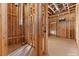 An unfinished hallway features wood framing, exposed ductwork, and wiring in the midst of construction at 5855 St Ebbes Ct, Las Vegas, NV 89131