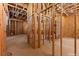 An unfinished hallway exhibiting wood framing and essential wiring, revealing construction progress at 5855 St Ebbes Ct, Las Vegas, NV 89131