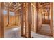 An unfinished hallway under construction has wooden framing, ventilation, and exposed plywood walls at 5855 St Ebbes Ct, Las Vegas, NV 89131