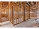 Unfinished hallway showcasing wood framing, plywood walls, and exposed ceiling in a new home build at 5855 St Ebbes Ct, Las Vegas, NV 89131