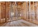 An unfinished laundry room showcases wood framing, plumbing, and electrical components during construction at 5855 St Ebbes Ct, Las Vegas, NV 89131