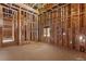 An unfinished office space showcases wood framing, exposed wiring, and window, highlighting construction in progress at 5855 St Ebbes Ct, Las Vegas, NV 89131