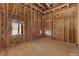 An unfinished office space showcases wood framing, exposed wiring, and window, highlighting construction in progress at 5855 St Ebbes Ct, Las Vegas, NV 89131