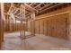 Unfinished primary bedroom showcasing wood framing, plywood walls, and exposed ceiling in a new home build at 5855 St Ebbes Ct, Las Vegas, NV 89131