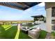 Stunning backyard oasis with lush landscaping, a fire pit, and panoramic city views at 6194 Stone Rise St, Las Vegas, NV 89135