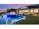 Stunning backyard with a pool, spa, outdoor kitchen, and seamless indoor-outdoor living space at 6194 Stone Rise St, Las Vegas, NV 89135