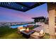 Outdoor oasis with a cozy fire pit, a stainless grill, a pool, and city views at 6194 Stone Rise St, Las Vegas, NV 89135