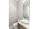Half bathroom featuring marble-like wallpaper and unique sink at 6194 Stone Rise St, Las Vegas, NV 89135