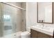 Modern bathroom with glass shower enclosure and wood vanity at 6194 Stone Rise St, Las Vegas, NV 89135