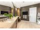 Bathroom with double vanity, makeup area, TV and floor to ceiling mirror at 6194 Stone Rise St, Las Vegas, NV 89135