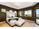 Spacious primary bedroom boasts tray ceilings, wood floors and a large window with a view at 6194 Stone Rise St, Las Vegas, NV 89135