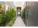 Modern entryway with garden view and luxurious stone pathway leading to a glass door at 6194 Stone Rise St, Las Vegas, NV 89135