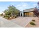 Charming single-story home with a brick driveway, modern design and desert landscaping at 6194 Stone Rise St, Las Vegas, NV 89135