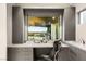 Bright home office featuring gray built-ins, marble countertops, and a window with a view at 6194 Stone Rise St, Las Vegas, NV 89135