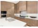 Contemporary kitchen boasts light wood cabinetry, and sleek stainless steel appliances at 6194 Stone Rise St, Las Vegas, NV 89135