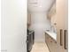A clean and modern laundry room with stainless steel appliances and built-in cabinetry at 6194 Stone Rise St, Las Vegas, NV 89135