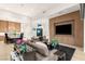 Modern living space with an open kitchen, dining area, large TV and ample seating at 6194 Stone Rise St, Las Vegas, NV 89135