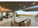 An expansive outdoor patio featuring a dining area with seating and amazing city views at 6194 Stone Rise St, Las Vegas, NV 89135