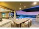Covered patio with ample seating and an outdoor kitchen perfect for entertaining and enjoying city views at 6194 Stone Rise St, Las Vegas, NV 89135