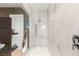 Walk-in shower featuring marble tile, glass doors and modern fixtures at 6194 Stone Rise St, Las Vegas, NV 89135