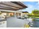 Luxury backyard with a sleek pool, spa, and an outdoor kitchen under a pergola at 6194 Stone Rise St, Las Vegas, NV 89135