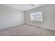 Neutral bedroom featuring carpet floors, bright walls and a large window at 6205 Windy Oaks Ct, Las Vegas, NV 89139
