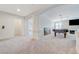 Large upstairs bonus room with neutral carpet, arched entryways, and open floor plan at 6205 Windy Oaks Ct, Las Vegas, NV 89139
