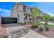 Paver driveway and desert landscaping lead to the home's entrance at 6205 Windy Oaks Ct, Las Vegas, NV 89139