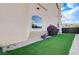 Exterior view shows landscaped artificial turf, bougainvillea, and attractive architecture at 6205 Windy Oaks Ct, Las Vegas, NV 89139
