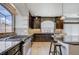 Beautiful kitchen features stainless steel appliances, dark cabinetry, granite countertops and a cooktop at 6205 Windy Oaks Ct, Las Vegas, NV 89139