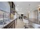 Open-concept design with kitchen featuring granite countertops, stainless appliances, and view to the living space at 6205 Windy Oaks Ct, Las Vegas, NV 89139