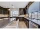 Well-lit kitchen with dark cabinets, granite countertops, stainless steel appliances and tile backsplash at 6205 Windy Oaks Ct, Las Vegas, NV 89139