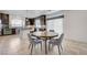 Open kitchen with a large round table, stainless steel appliances and beautiful dark cabinetry at 6205 Windy Oaks Ct, Las Vegas, NV 89139