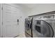 Modern laundry room featuring front-load washer and dryer units in a contemporary setting at 6205 Windy Oaks Ct, Las Vegas, NV 89139